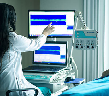 female doctor pointing at a screen of vitals