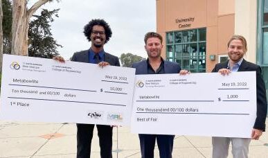 Winners of New Venture competition holding large checks