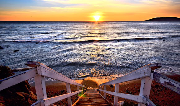 stairs leading to beach at sunset