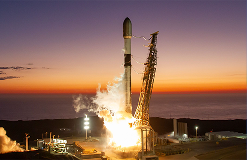 A SpaceX rocket launches at dusk in June 2024