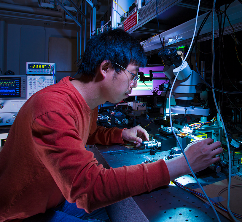 a man working with photonics equipment